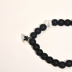 Detail showing matte black beads and marble white bead with magnetic heart clasp