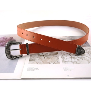 Three-piece retro engraved brown leisure belt with vintage metal buckle on a magazine
