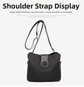 Detail view of adjustable shoulder strap and metal buckle on black minimalist crossbody bag