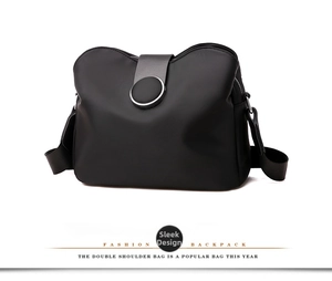 Detail view of the black waterproof nylon bag featuring grey decorative strap and magnetic buckle