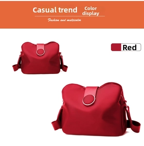 Detail view of red nylon crossbody phone bag with adjustable strap and metal buckle