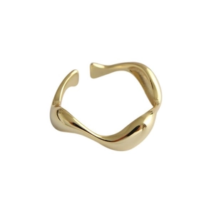 Minimalist irregular wavy gold open ring with polished metallic finish on white background
