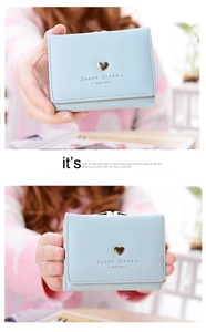 Detail of light blue short wallet with gold heart metal clasp and textured PU leather
