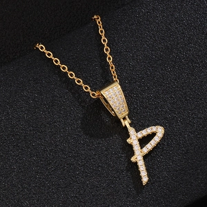 Macro shot of gold-plated letter P pendant necklace with sparkling pavé zircons