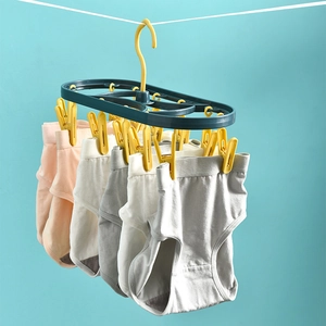 Yellow 12-clip plastic drying rack for underwear and socks on blue background