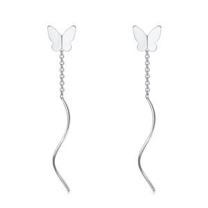 Detailed macro shot of silver butterfly drop earrings with elegant wavy long tassels