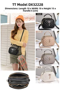 Detail view of quilted handbag with triple zipper design and metal bow tassel charm