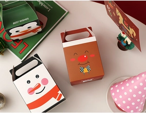 Detailed view of three festive Christmas gift boxes with penguin and snowman patterns