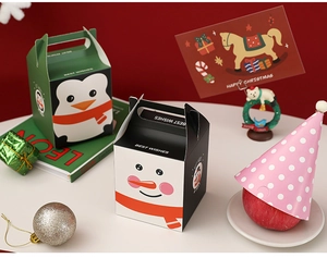 Close-up of festive Christmas gift boxes featuring cartoon penguin and snowman designs