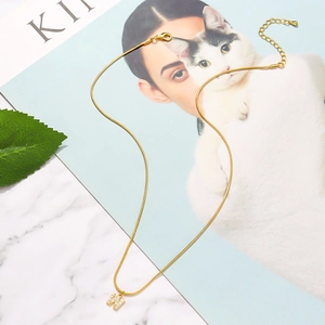 Adjustable golden snake chain necklace featuring a zircon-encrusted letter W pendant