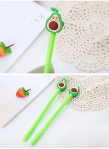 Close-up of cute green avocado cartoon gel pens with silicone toppers on a desk