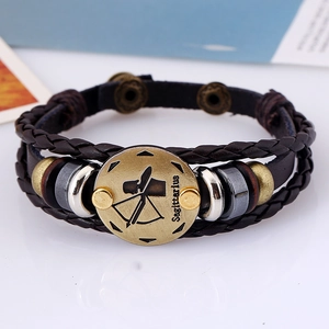 Macro detail of braided leather Sagittarius bracelet with bronze alloy charms