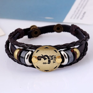 Detail view of woven leather bracelet with a Virgo sign bronze charm and metal beads