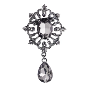 Vintage silver brooch with oval grey gemstone, intricate filigree and crystal rhinestones