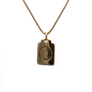 Detailed view of a gold rectangular copper pendant necklace with a circular accent