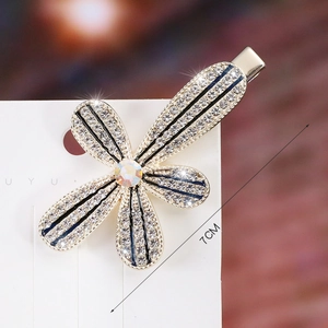 Close-up of 7cm elegant floral hair clip with crystals and blue accents on a card