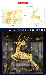 Close-up of golden Christmas window decals with reindeer, snowflakes and stars