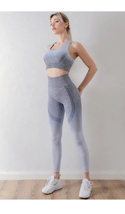 Detail of high waist seamless yoga leggings and sports bra set in blue gradient texture