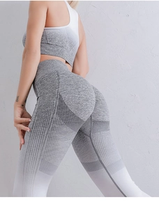 Detail showing high-waisted seamless yoga pants with gradient grey knit and breathable holes