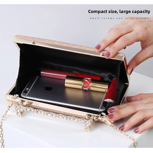 Internal view of sparkling glitter evening bag holding a smartphone and lipsticks