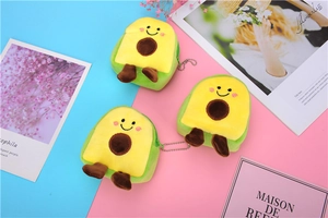 Detailed view of three plush avocado coin purses in green, yellow and brown colors
