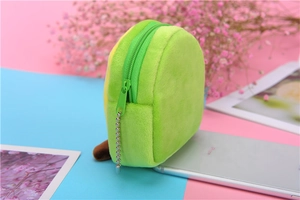 Close-up of plush avocado coin purse showing green fabric texture and zipper detail