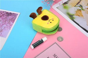 Macro shot of an avocado plush coin purse with a cute smiling face and green zipper detail