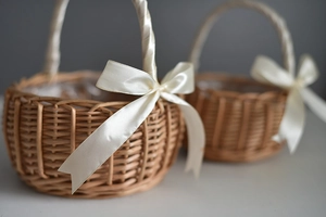 Close-up of woven wicker basket with cream ribbon bow and waterproof plastic liner detail