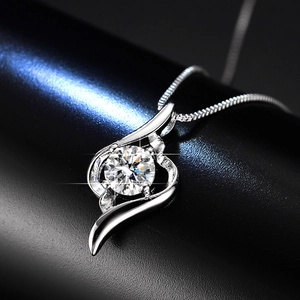 Macro shot of 1ct moissanite necklace with a streamline wave pendant and box chain