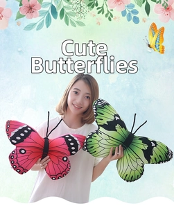 Close-up of plush butterfly pillows in red and green with realistic wing patterns