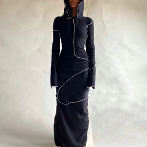 Detail of deconstructed black hooded maxi dress featuring contrast white outer stitching