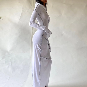 Detail view of white bodycon hooded dress featuring decorative grey exposed stitching