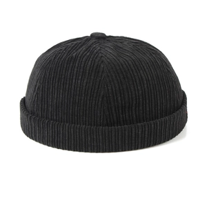 Close-up of black corduroy fabric texture and round silhouette of the docker hat