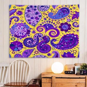 Detailed close-up of yellow and purple paisley tapestry hanging on a white wooden wall