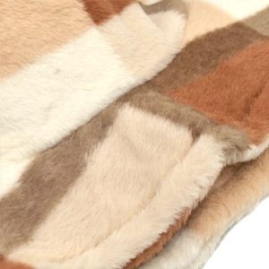 Close-up of soft plush faux fur fabric with multi-color checkered pattern on winter hat