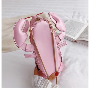 Close-up of pink lobster crossbody bag featuring fine 3D stitching and a gold chain strap