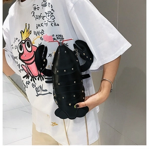 Detailed side view of a cute 3D lobster cross-body bag with golden studs and chain