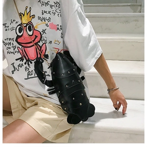 Detail of cute black lobster crossbody bag with gold studs and metal chain strap