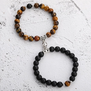 Close-up of magnetic coupling on tiger eye and matte black stone couple bracelets