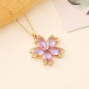 Pink crystal cherry blossom pendant necklace with gold chain and floral design