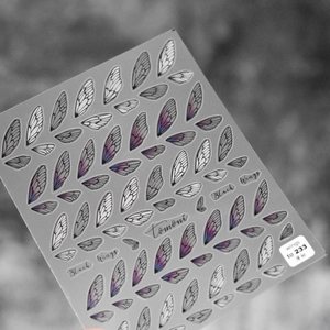 Detail view of 5D Black Wings nail stickers with delicate blue and purple gradient patterns