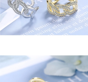 Macro detail of micro-pave Cuban chain ring with sparkling zircons in gold and silver finish