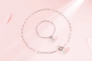 Detail of silver chain necklace and bracelet set with crystal ball charms and OT clasps