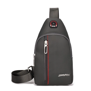 Close-up of small dark grey nylon chest bag with red stitching and durable zipper