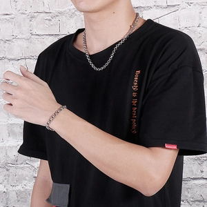 Men's silver stainless steel curb chain necklace and bracelet set shown on model