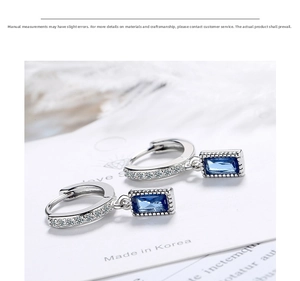 Close-up of S925 silver hoop earrings with blue square gems and micro-pave crystals