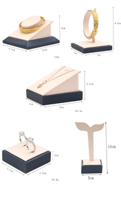 Detail view of navy blue and pink velvet jewelry display stands with dimensions