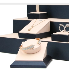Navy blue brushed PU leather jewelry display set showing rings and bracelets