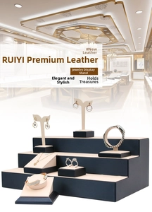Detailed view of dark blue PU leather tiered jewelry display stands for necklaces and rings