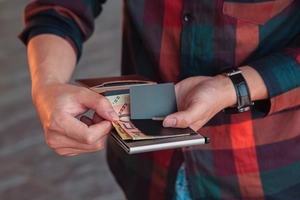 Close-up of minimalist RFID metal wallet showing bill clip and cash storage function